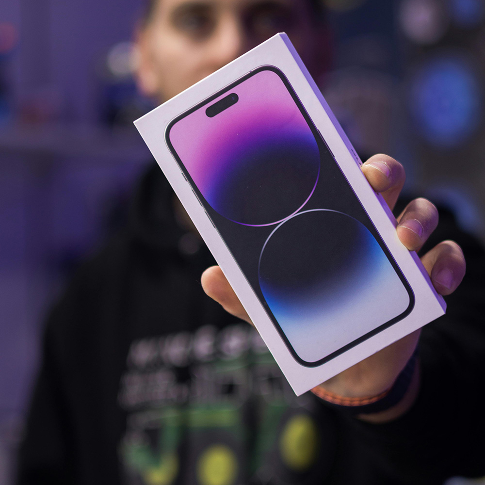 Person holding iPhone 15 Pro Max box representing professional iPhone repair services and trusted repair shops on iPhoneFix